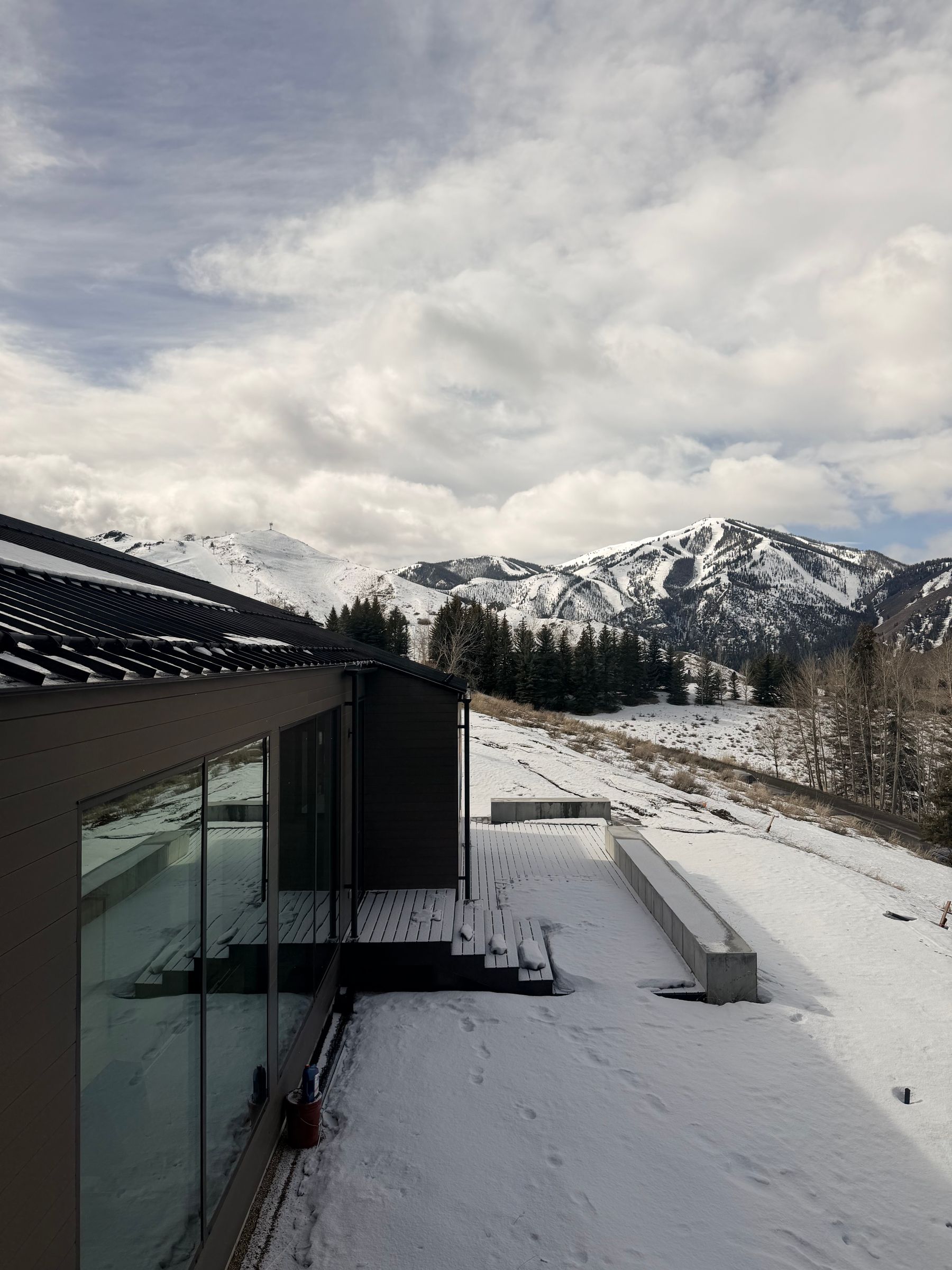 Modern mountain home overlooking snowy slopes