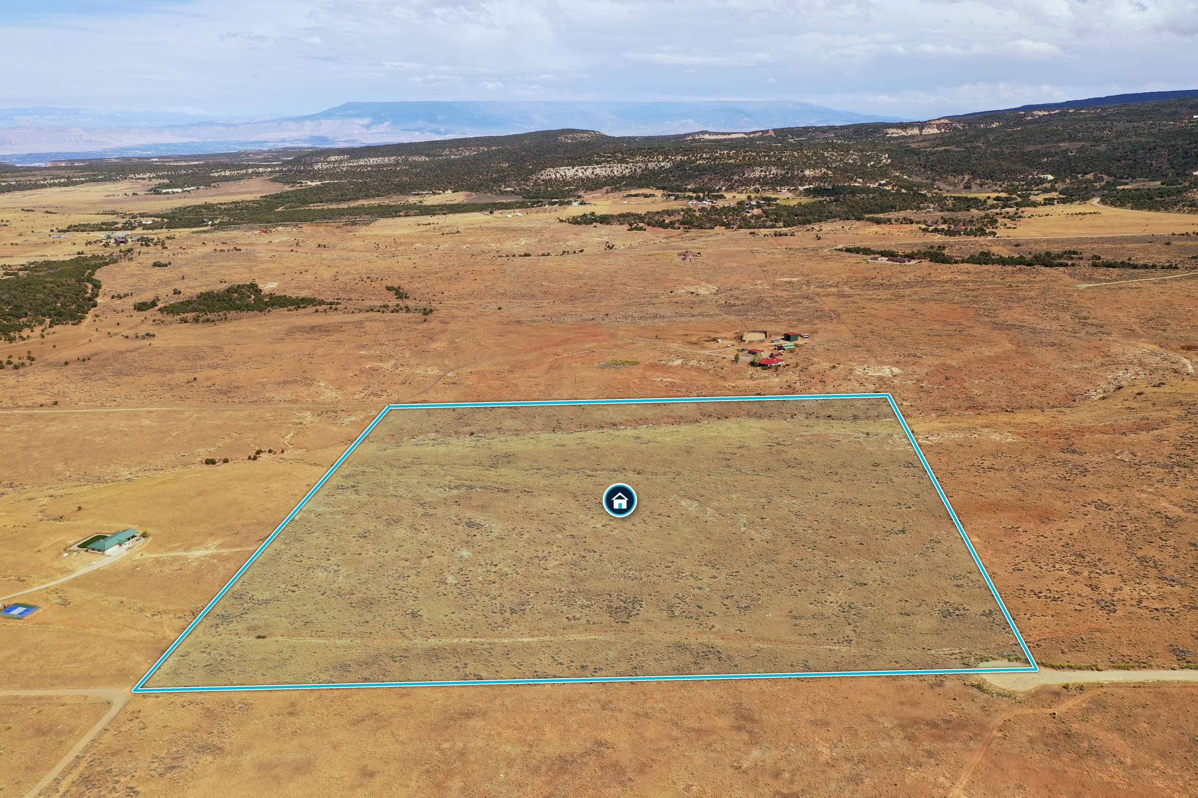 Aerial photograph with a cyan outline illustrating the property boundary